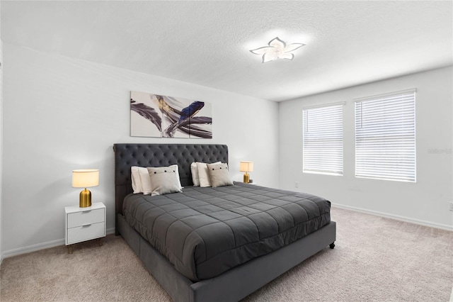 bedroom featuring a textured ceiling, baseboards, and carpet