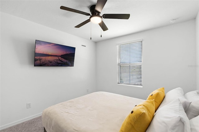 carpeted bedroom featuring baseboards and ceiling fan