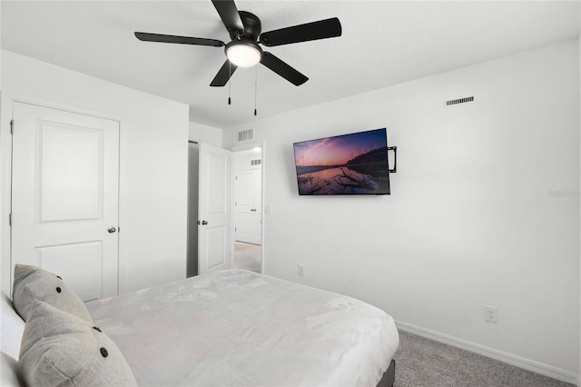 bedroom with visible vents, baseboards, light colored carpet, and a ceiling fan