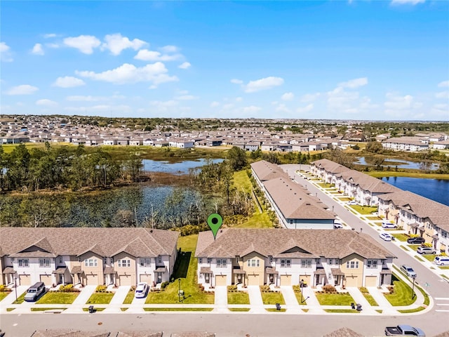 drone / aerial view featuring a residential view and a water view