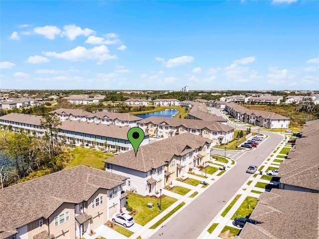 birds eye view of property with a residential view and a water view