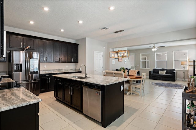 kitchen with visible vents, light tile patterned flooring, a sink, appliances with stainless steel finishes, and open floor plan