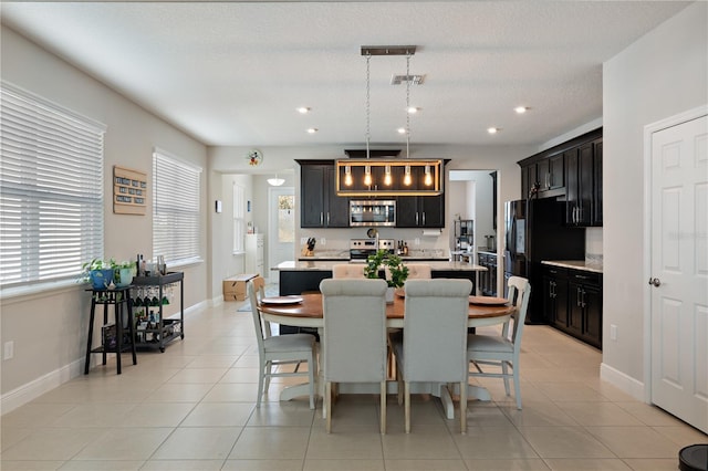 dining area featuring recessed lighting, light tile patterned floors, baseboards, and visible vents