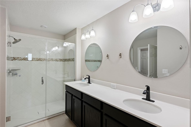 bathroom with a sink, a stall shower, and tile patterned flooring