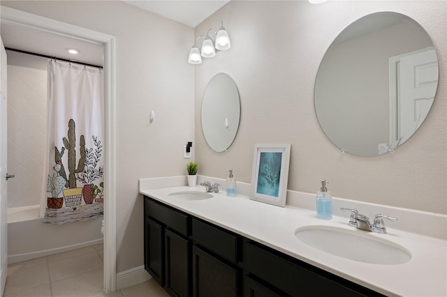 full bathroom with tile patterned flooring, shower / bath combination with curtain, double vanity, and a sink