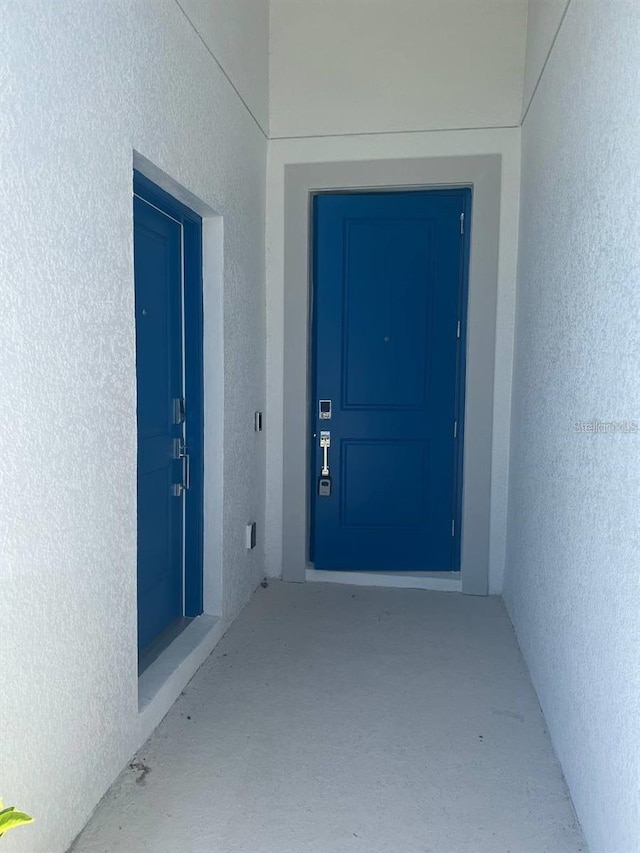 entrance to property featuring stucco siding