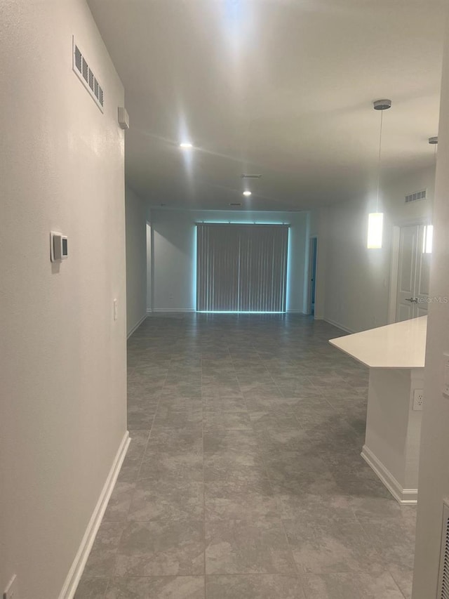 unfurnished room with visible vents and baseboards