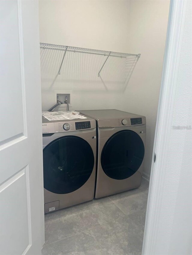 washroom featuring laundry area and separate washer and dryer