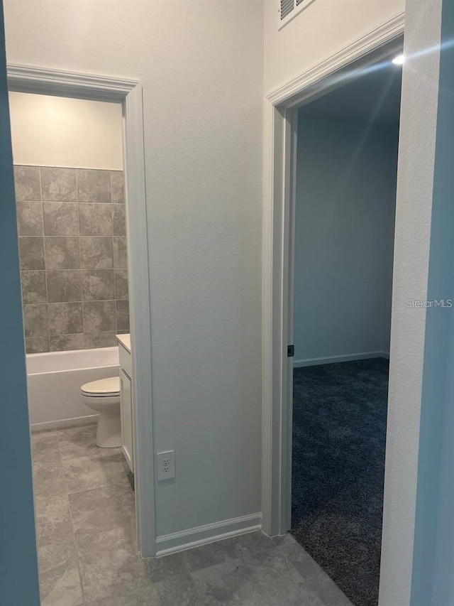 full bathroom with a tub and toilet