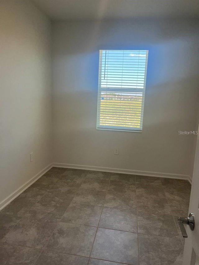 unfurnished room featuring baseboards