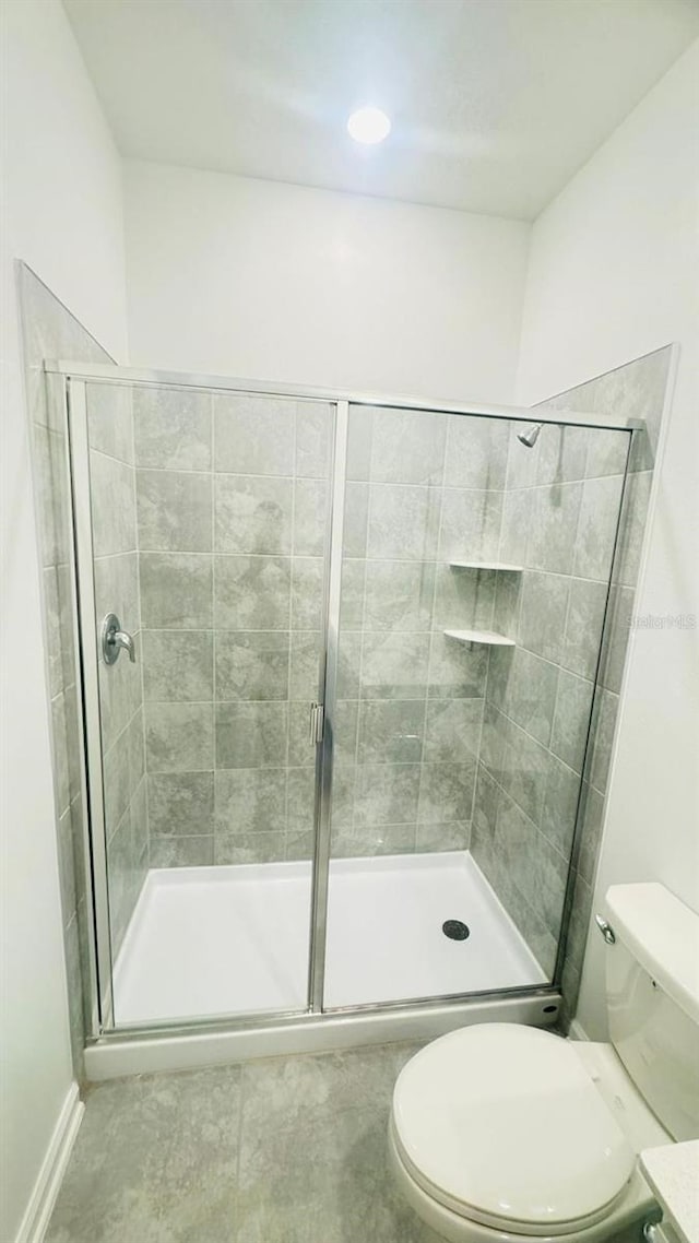 full bath with a stall shower and toilet