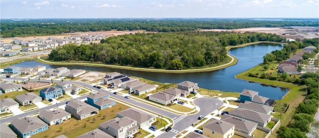 birds eye view of property with a residential view, a wooded view, and a water view