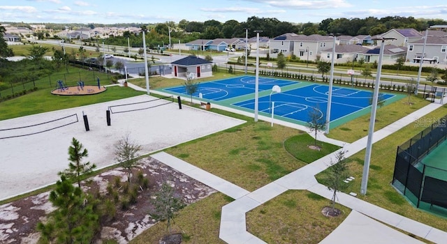 exterior space featuring fence, volleyball court, a yard, community basketball court, and a residential view