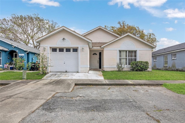 ranch-style house featuring a garage, stucco siding, driveway, and a front yard