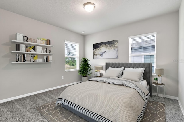 carpeted bedroom with baseboards and a textured ceiling