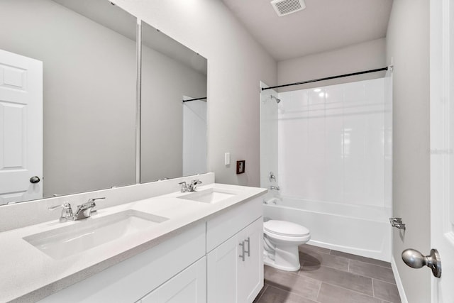 bathroom featuring a sink, visible vents, toilet, and double vanity