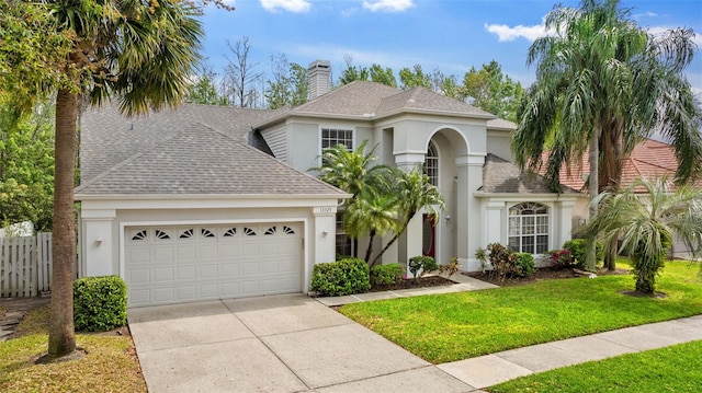 view of front of house with a front yard, a chimney, a shingled roof, concrete driveway, and a garage