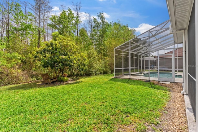 view of yard featuring an outdoor pool and glass enclosure