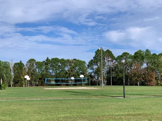 view of home's community with a lawn and volleyball court