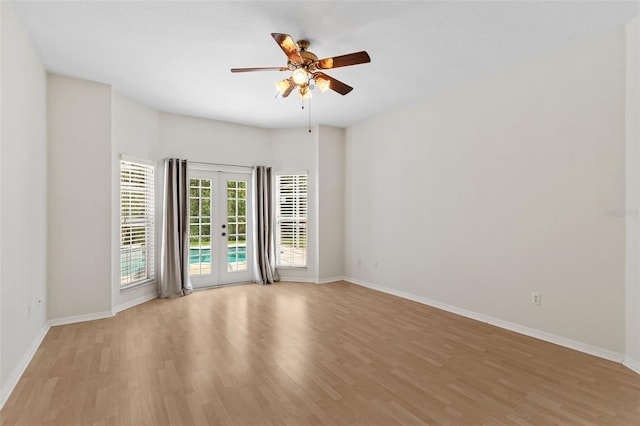 unfurnished room featuring a ceiling fan, french doors, light wood-style floors, and baseboards