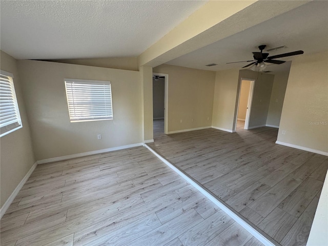 unfurnished room featuring a wealth of natural light, a ceiling fan, and wood finished floors