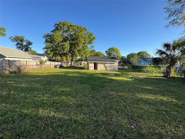 view of yard featuring an outdoor structure and a fenced backyard