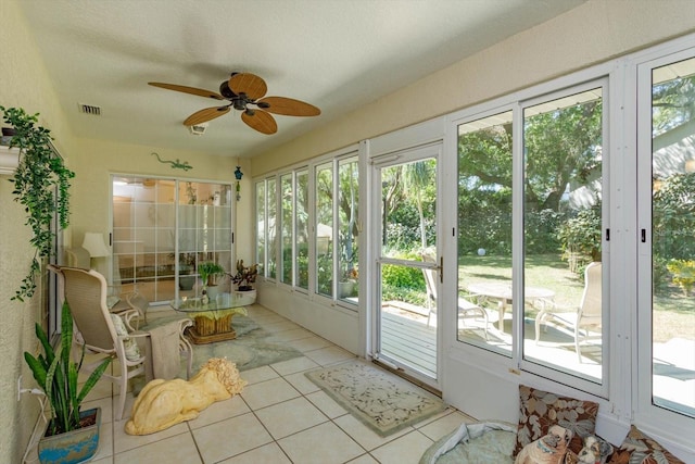 sunroom / solarium with tile patterned flooring, plenty of natural light, french doors, and visible vents