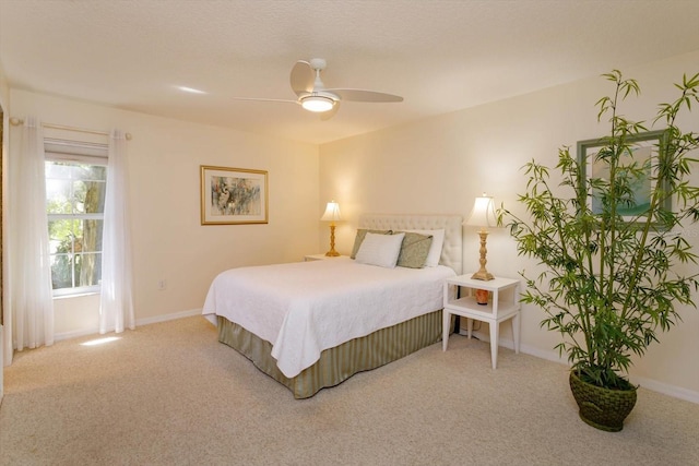 carpeted bedroom with a ceiling fan and baseboards