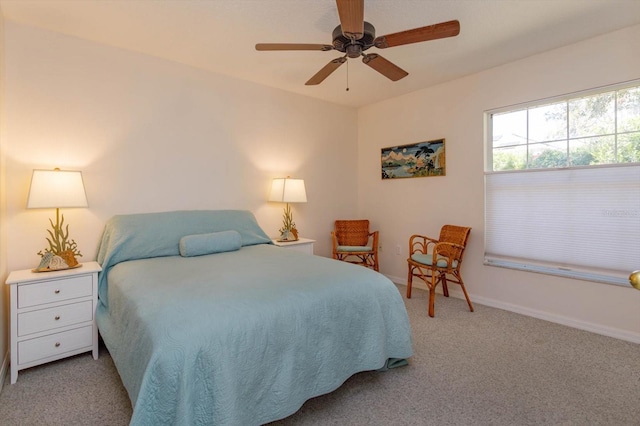 carpeted bedroom with a ceiling fan and baseboards
