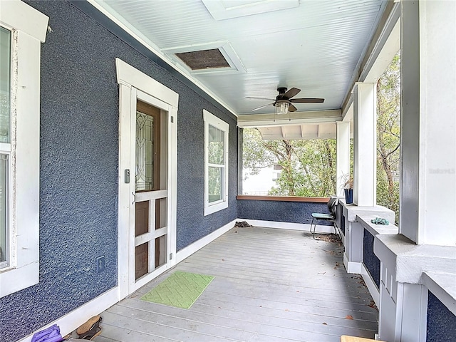 unfurnished sunroom with a ceiling fan and visible vents