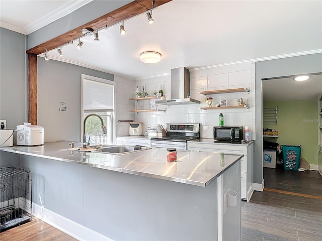 kitchen featuring wall chimney range hood, open shelves, stainless steel range with electric stovetop, and stainless steel counters