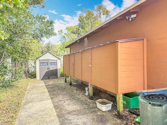 view of side of home with an outbuilding and a shed