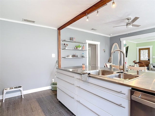 kitchen with visible vents, crown molding, stainless steel dishwasher, white cabinets, and a sink