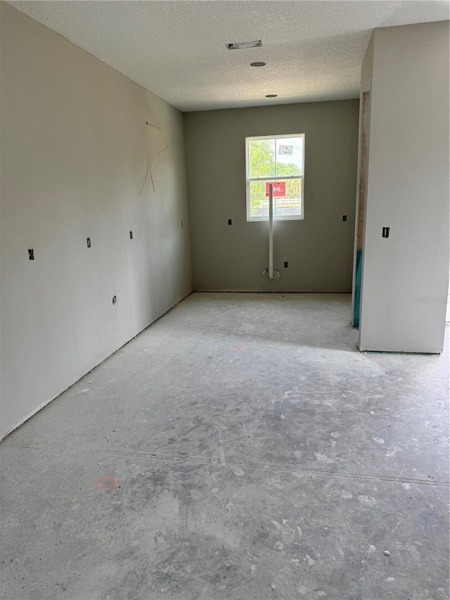 3027 Turkey Ave, Oviedo, FL 32765 - unfurnished room featuring a textured ceiling and unfinished concrete floors