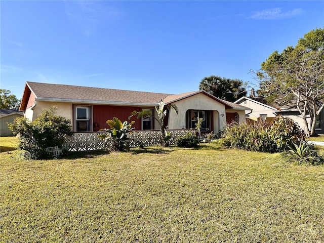 ranch-style home with stucco siding and a front yard