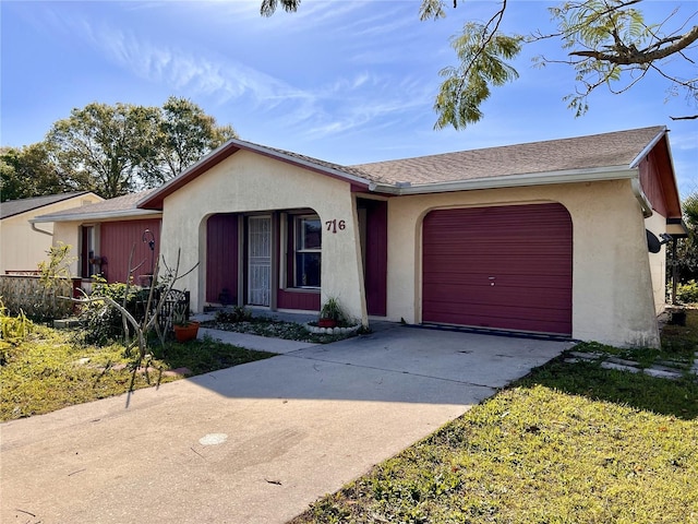 single story home featuring stucco siding, concrete driveway, and a garage