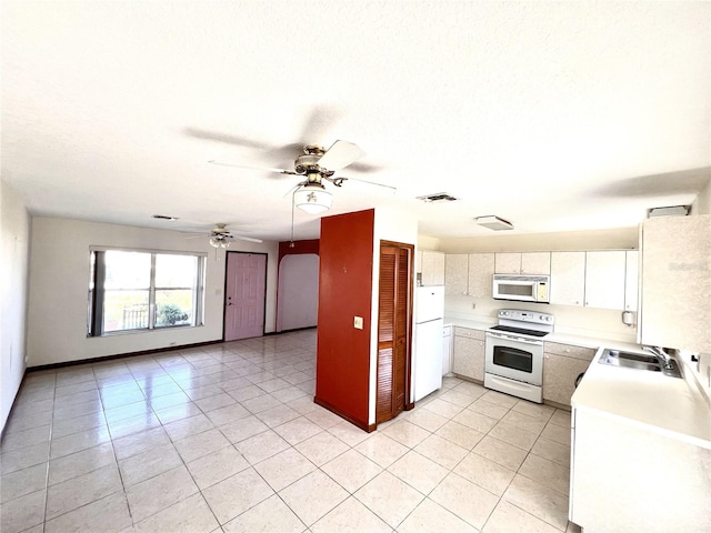 kitchen with white appliances, a ceiling fan, visible vents, a sink, and light countertops