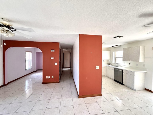 kitchen with visible vents, arched walkways, light countertops, dishwasher, and ceiling fan