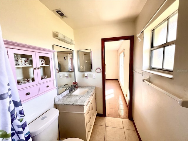 bathroom with visible vents, baseboards, toilet, tile patterned floors, and vanity