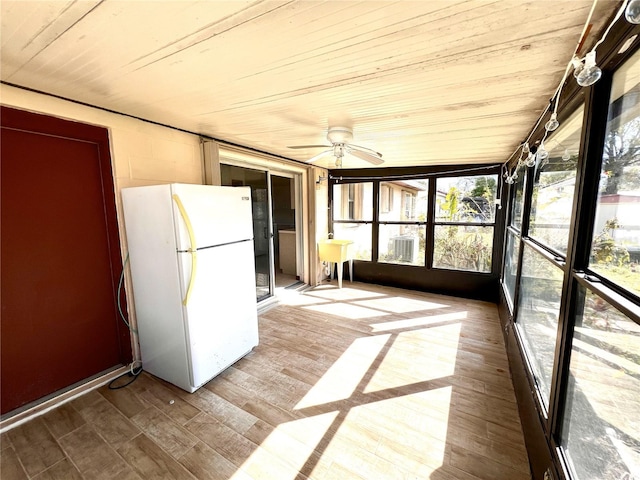 unfurnished sunroom featuring wooden ceiling and a ceiling fan