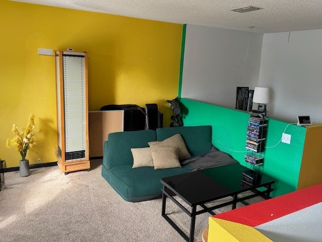 living room featuring carpet flooring, visible vents, and a textured ceiling