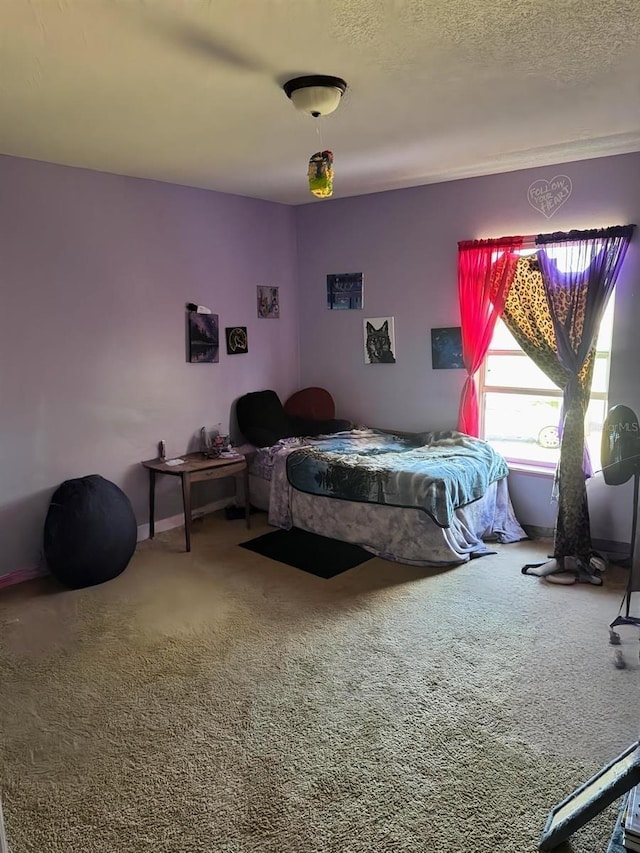 bedroom with carpet and a textured ceiling