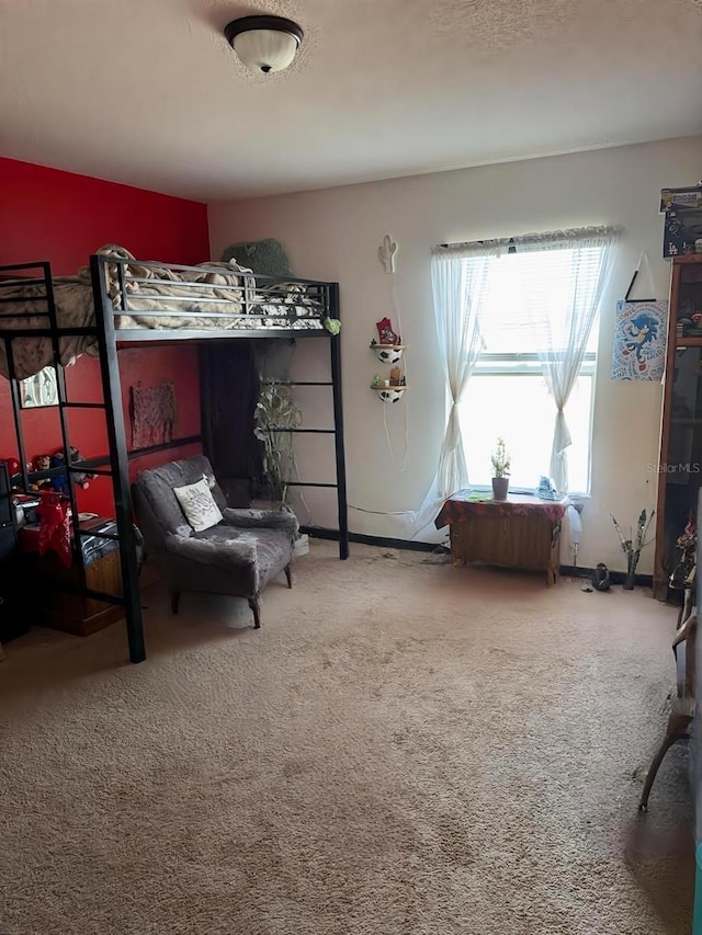 carpeted bedroom featuring baseboards