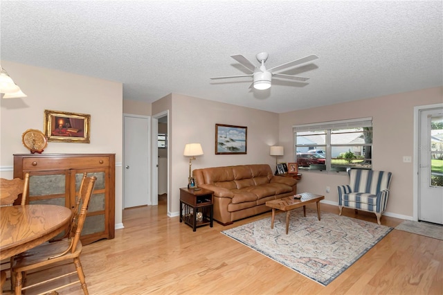 8787 SW 90th Ln Unit E, Ocala, FL 34481 - living area with light wood-style flooring, a healthy amount of sunlight, and ceiling fan