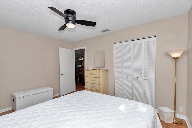 8787 SW 90th Ln Unit E, Ocala, FL 34481 - bedroom with a textured ceiling, a closet, baseboards, and visible vents