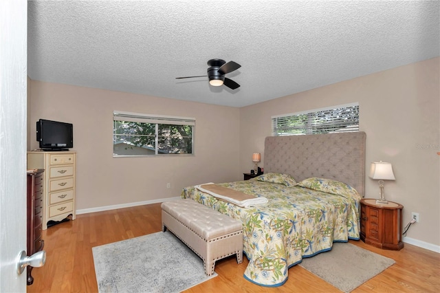 8787 SW 90th Ln Unit E, Ocala, FL 34481 - bedroom with wood finished floors, ceiling fan, baseboards, and multiple windows