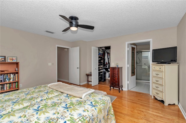 8787 SW 90th Ln Unit E, Ocala, FL 34481 - bedroom featuring visible vents, a closet, a spacious closet, light wood-style floors, and ensuite bath