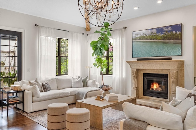 living area with dark wood-type flooring, recessed lighting, a healthy amount of sunlight, and a chandelier