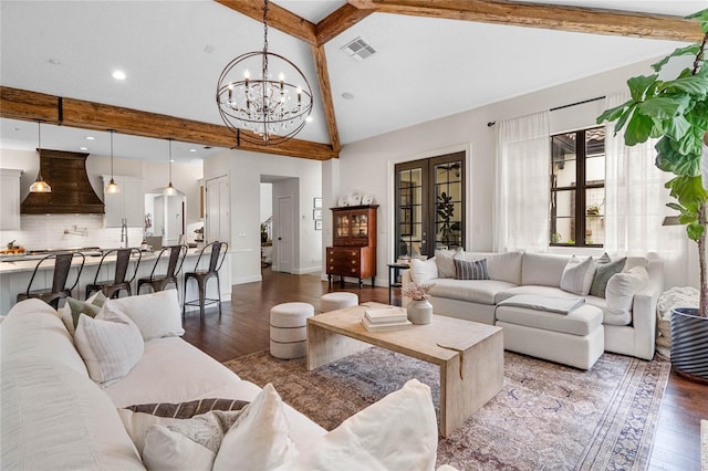 living area featuring visible vents, baseboards, dark wood finished floors, beamed ceiling, and a notable chandelier