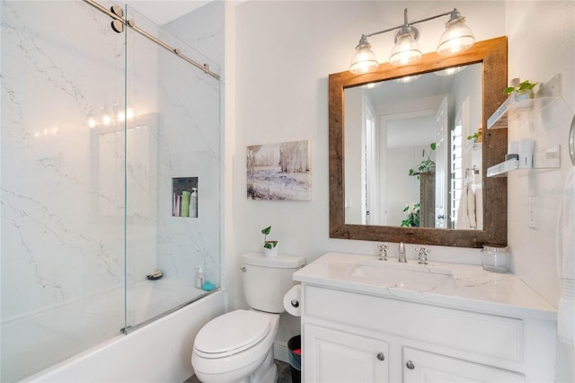 bathroom with vanity, toilet, and bath / shower combo with glass door